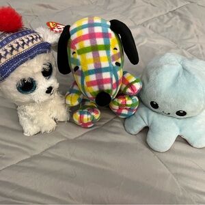 Three stuffed animals — Sleighbell, Snoopy and Octopus